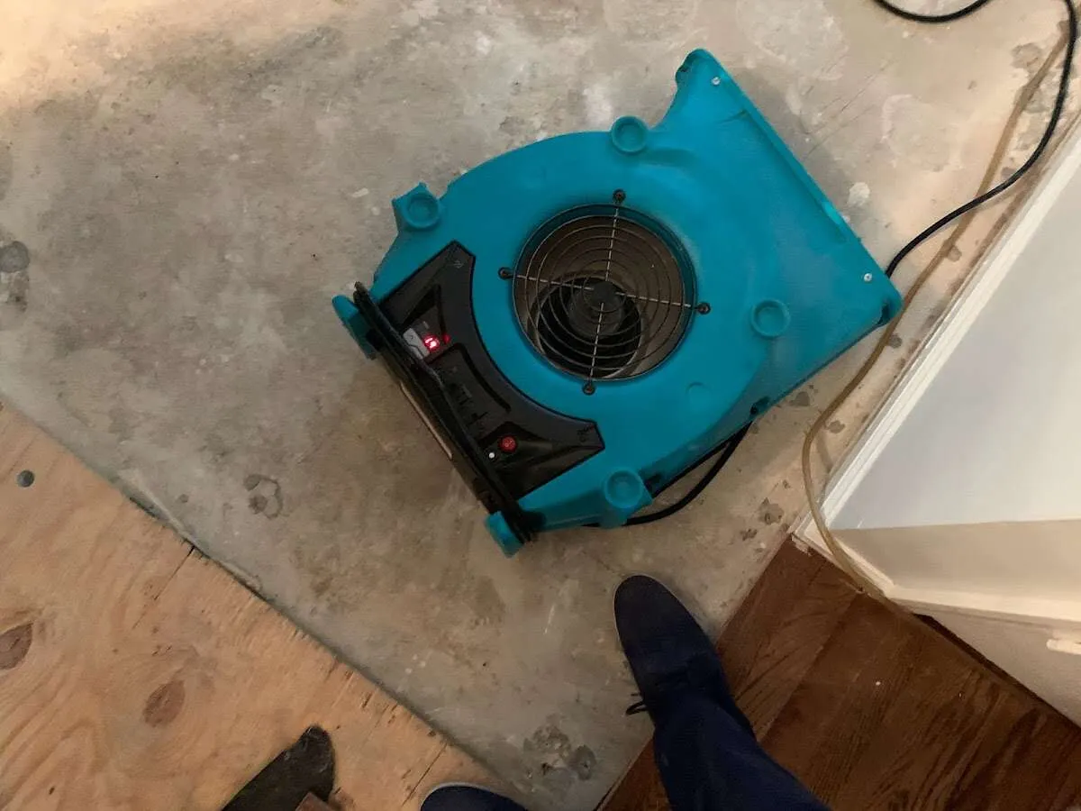 Air mover drying subfloor during Commercial Water Damage Restoration in North Smithfield
